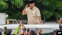 FILE - Indonesian Defense Minister Prabowo Subianto greets supporters in Jakarta, Indonesia, Feb. 15, 2024. 