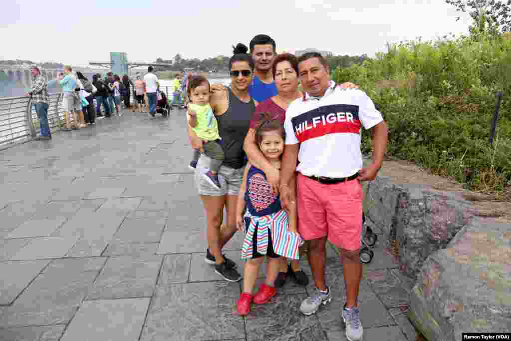 Guatemalan-native Victor Manuel, right, with his wife and friends from Ecuador, drove to Niagara Falls from Queens, New York. “We want our youth to know the good and beauty of sharing traditions with family,” Manuel said. (R. Taylor/VOA)
