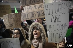Demonstrators protest President Donald Trump's travel ban from seven Muslim-majority countries at the international terminal at O'Hare Airport, Jan. 29, 2017, in Chicago, Illinois.