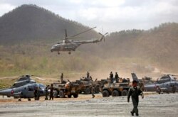 FILE - Cambodia's and China's army soldiers attend the opening of military exercise in Kampong Speu province, Cambodia, March 17, 2018.