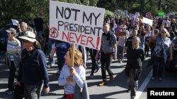 FILE - A woman holds a sign during a protest against President-elect Donald Trump at Golden Gate Park in San Francisco, California, Nov. 13, 2016.