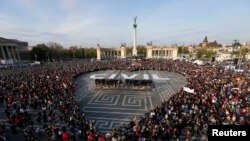 FILE - People protest in Heroes’ Square against a new law that would undermine Central European University, a liberal graduate school of social sciences founded by U.S. financier George Soros in Budapest, Hungary, April 12, 2017.