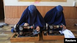 Afghan women attend tailoring class at the Skills Academy for Needy Aspirants, in Peshawar