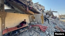Pria Palestina Sami Abu Nasser beristirahat di depan reruntuhan rumahnya yang hancur dalam serangan militer Israel, di Khan Younis, Jalur Gaza selatan, 4 November 2024. (Mohammed Salem/REUTERS)