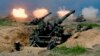 FILE - US-made CM-11 tanks (in background) are fired in front of two 8-inch self-propelled artillery guns during the 35th 'Han Kuang' (Han Glory) military drill in southern Taiwan's Pingtung county on May 30, 2019. 
