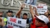 Demonstrators hold signs and a picture supporting Edward Snowden outside the Consulate General of the United States in Hong Kong, June 13, 2013.