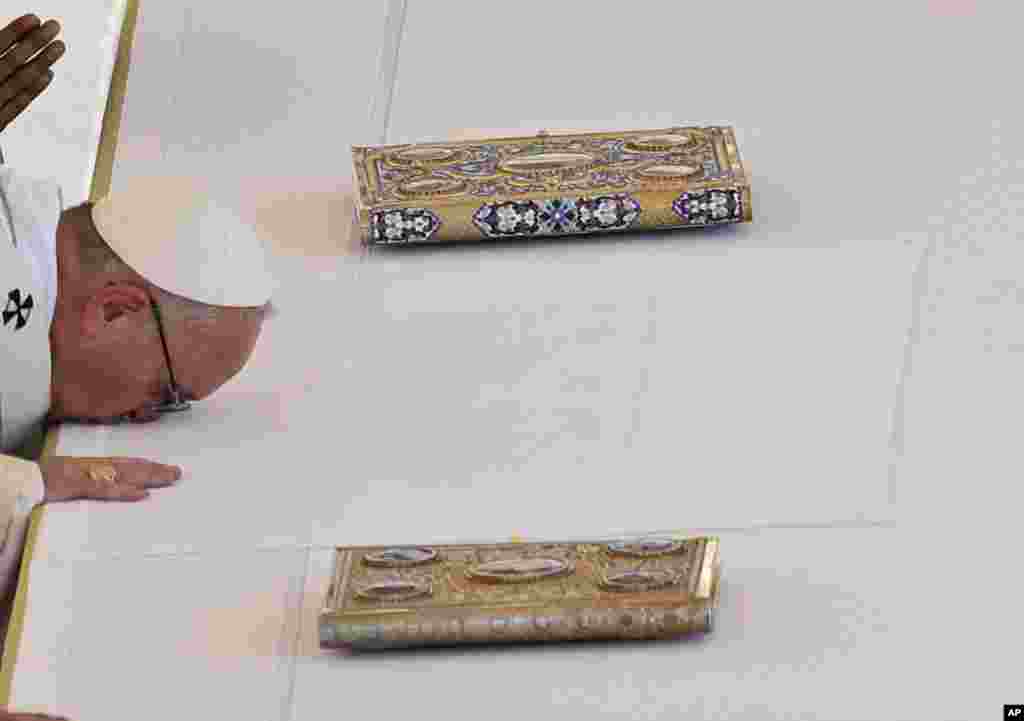 Pope Francis kisses the altar ahead of a Canonization Mass for Mother Teresa, in St. Peter's Square at the Vatican, Sept. 4, 2016. Francis has declared Mother Teresa a saint, honoring the tiny nun who cared for the world's most destitute as an icon for a Catholic Church that goes to the peripheries to find poor, wounded souls.
