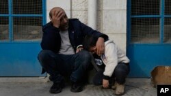 Mourners wait outside a morgue for the funeral of six Palestinians killed during an Israeli airstrike on Wednesday in the West Bank refugee camp of Jenin, Jan. 16, 2025.