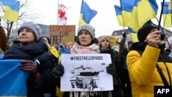 A protester holds a placard during a demonstration in support of Ukraine, during a Foreign Affairs Council meeting at the EU headquarters in Brussels on Jan. 23, 2023.