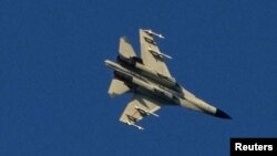 A Chinese People's Liberation Army (PLA) aircraft flies over the 68-nautical-mile scenic spot, one of mainland China's closest points to the island of Taiwan, in Pingtan island, Fujian province, China August 5, 2022. 