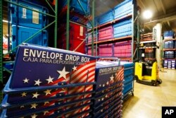 FILE - The warehouse at the Maricopa County Elections Department stores all the equipment and signage for all the voting precincts in Phoenix, Sept. 8, 2022.