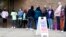 People line up outside a polling station to cast their votes in Milwaukee, Wisconsin, Oct. 25, 2022.