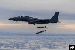 Jet tempur F15K Angkatan Udara Korea Selatan menembakkan 2 bom JDAM (Joint Direct Attack Munition) ke sebuah pulau sasaran di Korea Selatan, Selasa, 4 Oktober 2022. (Foto: via AP)