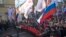 Demonstrators carry portraits of slain opposition leader Boris Nemtsov and a big poster reading "Killed for Freedom" during a march marking the one-year anniversary of his killing, in Moscow, Russia, Feb. 27, 2016.