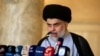 Iraqi Shi'ite cleric Muqtada al-Sadr delivers a sermon to worshippers during Eid al-Fitr prayers at the Kufa mosque near Najaf, June 5, 2019. 