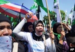 Suda Hemsanga, a Krabi resident, yells in protest against a proposed coal-fired plant on Thailand's coast, in Bangkok, Thailand, Feb. 17, 2017.