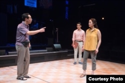A scene from 'Cambodian Rock Band' where Chum, played by Joe Ngo, confronted his daughter, Neary, played by Brooke Ishibashi, while her husband Ted, played by Moses Villarama, was standing by. ( Photo by Jenny Graham, Oregon Shakespeare Festival)