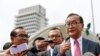 FILE - Cambodia's exiled opposition leader Sam Rainsy talks to the media outside Parliament House in Kuala Lumpur, Malaysia, Tuesday, Nov. 12, 2019. (AP Photo/Vincent Thian)