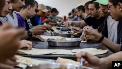 Juveniles linked to the Islamic State group eat lunch in a rehabilitation center outside Qamishli, Syria, May 11, 2023. 