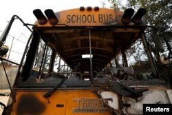 A school bus burned by the Eaton Fire stands on a street in Altadena, California, Jan.10, 2025.
