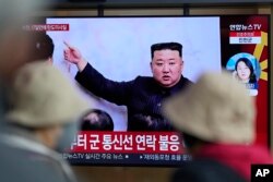 Sebuah layar TV terlihat melaporkan berita mengenai pemimpin Korea Utara Kim Jong Un di Stasiun Kereta Api Seoul di Seoul, Korea Selatan, Kamis, 13 April 2023. (Foto: AP)