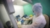 A medical staffer works with test systems for the diagnosis of coronavirus, at the Krasnodar Center for Hygiene and Epidemiology microbiology lab in Krasnodar, Russia, Feb. 4, 2020.