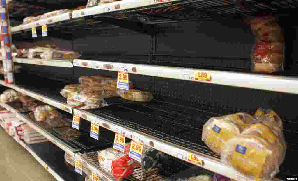 Almost empty shelves at a grocery store after people prepared for an ice storm in Lilburn outside Atlanta, Georgia, Feb. 12, 2014.