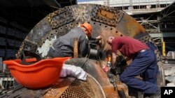 Workers repair part of a damaged thermal power plant, one of the country's largest, recently destroyed by Russian missiles near Kharkiv, Ukraine, on April 12, 2024.