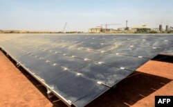 FILE - Solar panels are pictured at the new 15 MWp photovoltaic (PV) power plant supplying the Canadian mining company Iamgold's Essakane gold mine on its inauguration on March 16, 2018 near Dori in northern Burkina Faso.