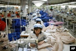 FILE - North Korean workers assemble jackets at a factory of a South Korean-owned company at the jointly run Kaesong Industrial Complex in Kaesong, North Korea.
