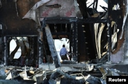 A security official investigates the aftermath of a fire at the Victoria Islamic Center mosque in Victoria, Texas, Jan. 29, 2017.
