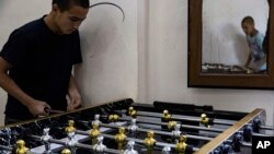 Children linked to the Islamic State group play foosball in a rehabilitation center outside Qamishli, Syria, May 11, 2023.
