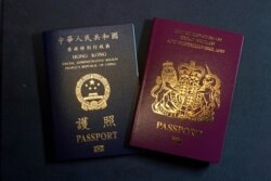 FILE - A British National Overseas passport (BNO), right, and a Hong Kong Special Administrative Region of the People's Republic of China passport are pictured in Hong Kong, Jan. 29, 2021.