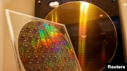 FILE - Two chips on display at the Taiwan Semiconductor Research Institute in Hsinchu, Taiwan, Feb. 11, 2022.