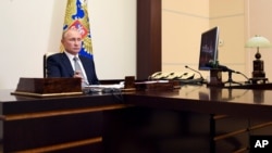 Russian President Vladimir Putin attends a meeting via video conference at the Novo-Ogaryovo residence outside Moscow, Russia, Sept. 3, 2020. 