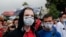 People gather to collect signatures to cancel the results of voting on amendments to the Constitution in Moscow, Russia, July 15, 2020. Writing on the face masks reads "no." 