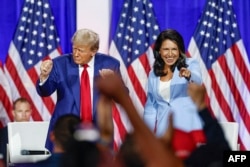 FILE - Former U.S. President Donald Trump leaves the stage with former U.S. Representative Tulsi Gabbard during a town hall meeting in La Crosse, Wisconsin, on Aug. 29, 2024.
