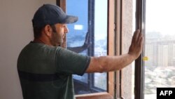 FILE- Tajik construction worker Zoir Kurbanov renovates a new apartment in Dushanbe, Sept. 17, 2023. While Russia has remained an attractive destination for Central Asian workers -- 1.3 million migrated from Kyrgyzstan, Tajikistan and Uzbekistan in the first quarter of 2023.