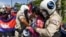 Local security personnel guards confiscate a loudspeaker from a protester during a protest to mark the 29th anniversary of the Paris Peace Accord in front of the US embassy in Phnom Penh on October 23, 2020. (Photo by TANG CHHIN Sothy/AFP)