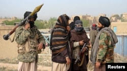 FILE - A group of Taliban fighters are seen in Ghazni province, Afghanistan, April 18, 2015.