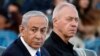 FILE - Israeli Prime Minister Benjamin Netanyahu, left, and Israeli Defense Minister Yoav Gallant attend a ceremony for the 70th cohort of military combat officers, at an army base near Mitzpe Ramon, Oct. 31, 2024. 