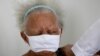 Justina Batista, 90, gets a shot of China's Sinovac vaccine in Brasilia, Brazil, Feb. 17, 2021.