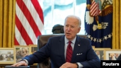 FILE PHOTO: U.S. President Joe Biden speaks before signing executive orders at the White House in Washington, Jan. 28, 2021.
