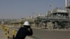 Seorang fotografer memotret ladang minyak Khurais, 50 km timur-timur laut Riyadh, Arab Saudi, 28 Juni 2021. (Foto: AP)