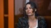 FILE - U.S.-Russian national Ksenia Karelina, also known as Ksenia Khavana, sits in a glass cage in a court room in Yekaterinburg, Russia, June 20, 2024. 
