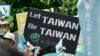 FILE - A demonstrator holds a placard in support of Taiwan during a rally ahead of an identity referendum in Taipei, October 20, 2018.