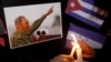 FILE - People place candles beside a picture of Fidel Castro, as part of a tribute, following the announcement of the death of the Cuban revolutionary leader, in Tegucigalpa, Honduras, Nov. 26, 2016.
