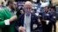 Frederick Reimer, center, works with fellow traders on the floor of the New York Stock Exchange, Jan. 27, 2017.