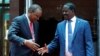 Kenya's President Uhuru Kenyatta, left, and opposition leader Raila Odinga of the National Super Alliance (NASA) coalition shake hands after a joint news conference in Nairobi, March 9, 2018. 