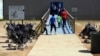 FILE - Photo provided by U.S. Immigration and Customs Enforcement shows immigrants walking into a building at South Texas Family Residential Center in Dilley, Texas.
